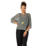 A woman wearing a gray popcorn knit top with three-quarter sleeves, paired with black pants. She is accessorized with a heart-shaped pendant necklace and hoop earrings.