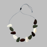Necklace with multicolored stones on a gray background