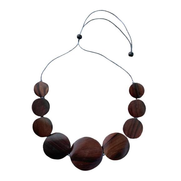 Wooden beaded necklace on a gray surface