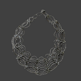 Silver bracelet on a gray fabric background