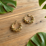 A pair of gold-plated spiral hoop stud earrings on a white background.