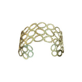 Gold bracelet on a wooden surface