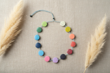 Colorful necklace with round beads on a white background