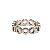 Silver ring with circular design on a light gray background
