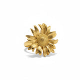 Gold sunflower-shaped ring on a white background