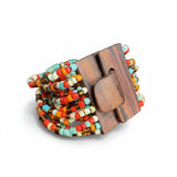 Suzie Blue Canada multi-strand seed bead bracelet with a wooden clasp, featuring red, orange, cream, and turquoise beads.