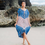 Suzie Blue Canada pink and blue tie-dye rayon kaftan dress with V-neck and short sleeves, worn on a beach.